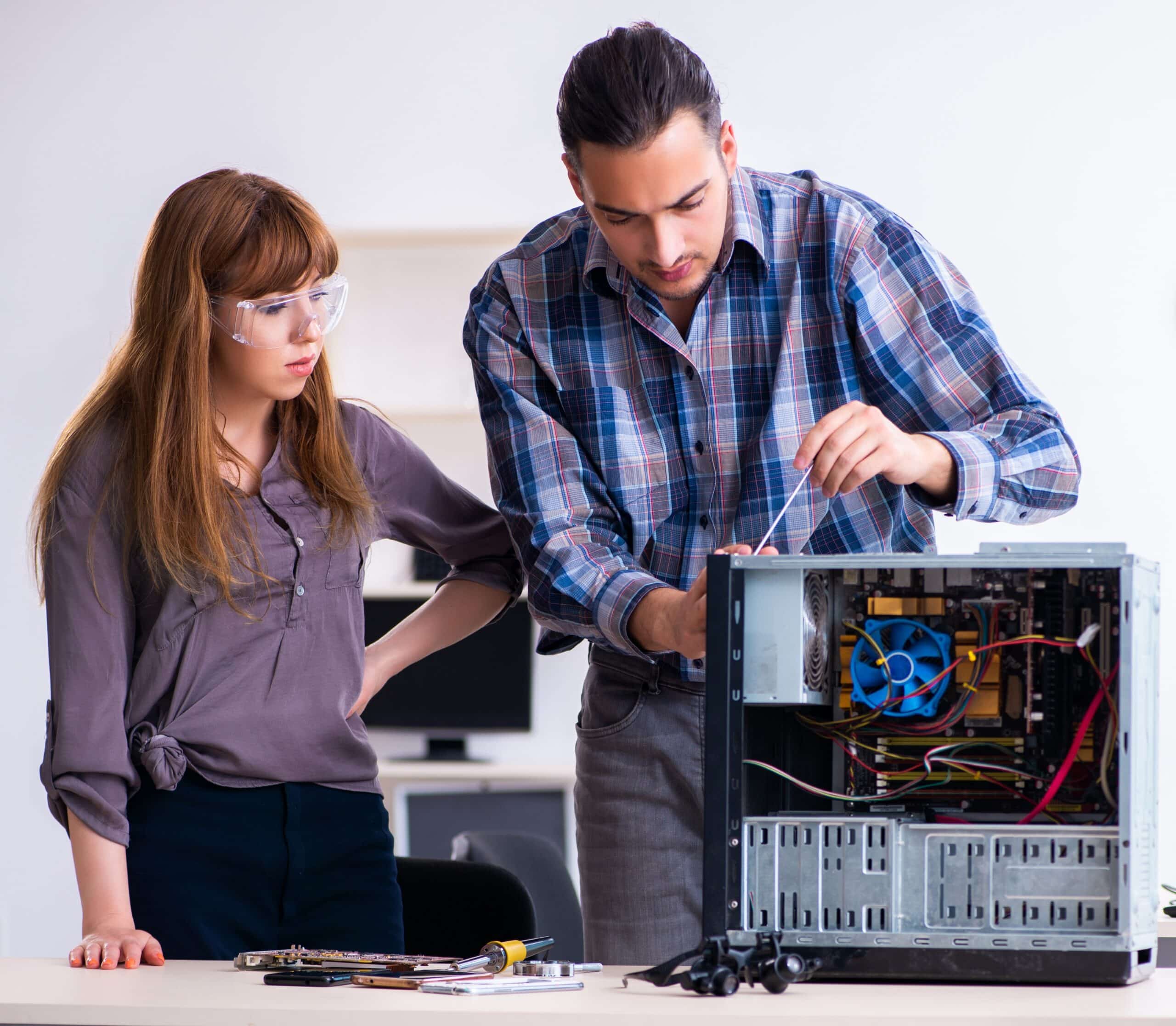 two repairmen repairing desktop computer