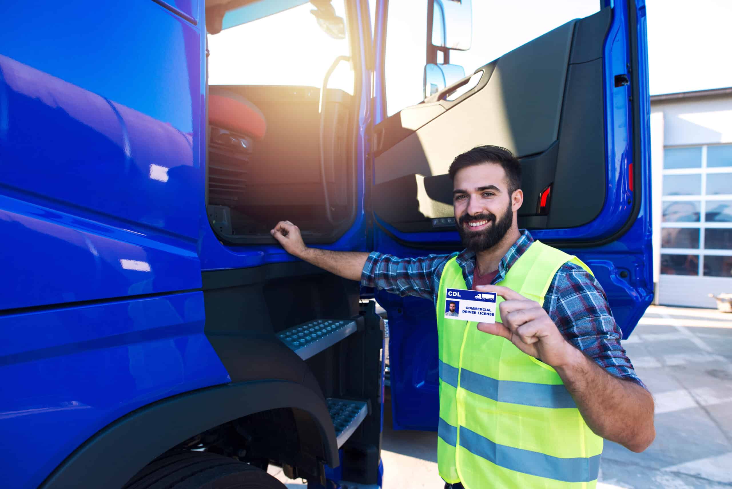 truck driver candidate showing cdl driving license for transportation vehicles.