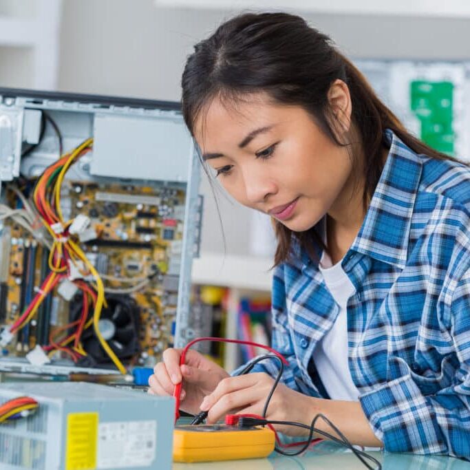 asian woman repairing computer