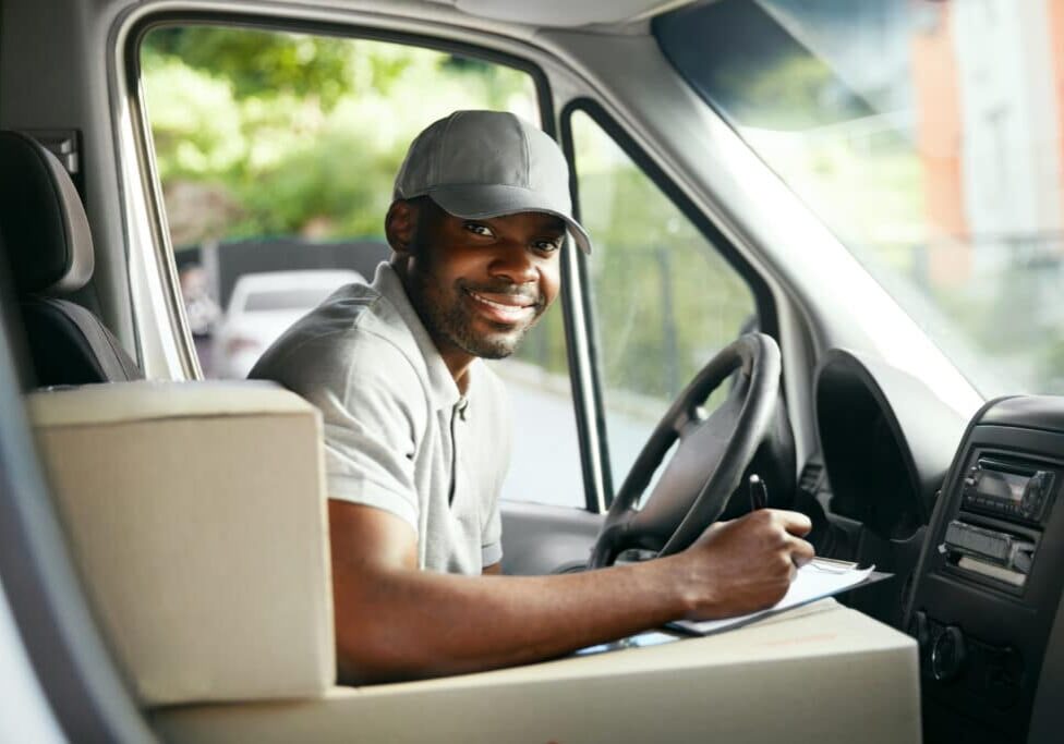 man driver driving delivery car